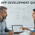An expert developer holds a tablet displaying wireframes while an entrepreneur asks active mobile app questions.